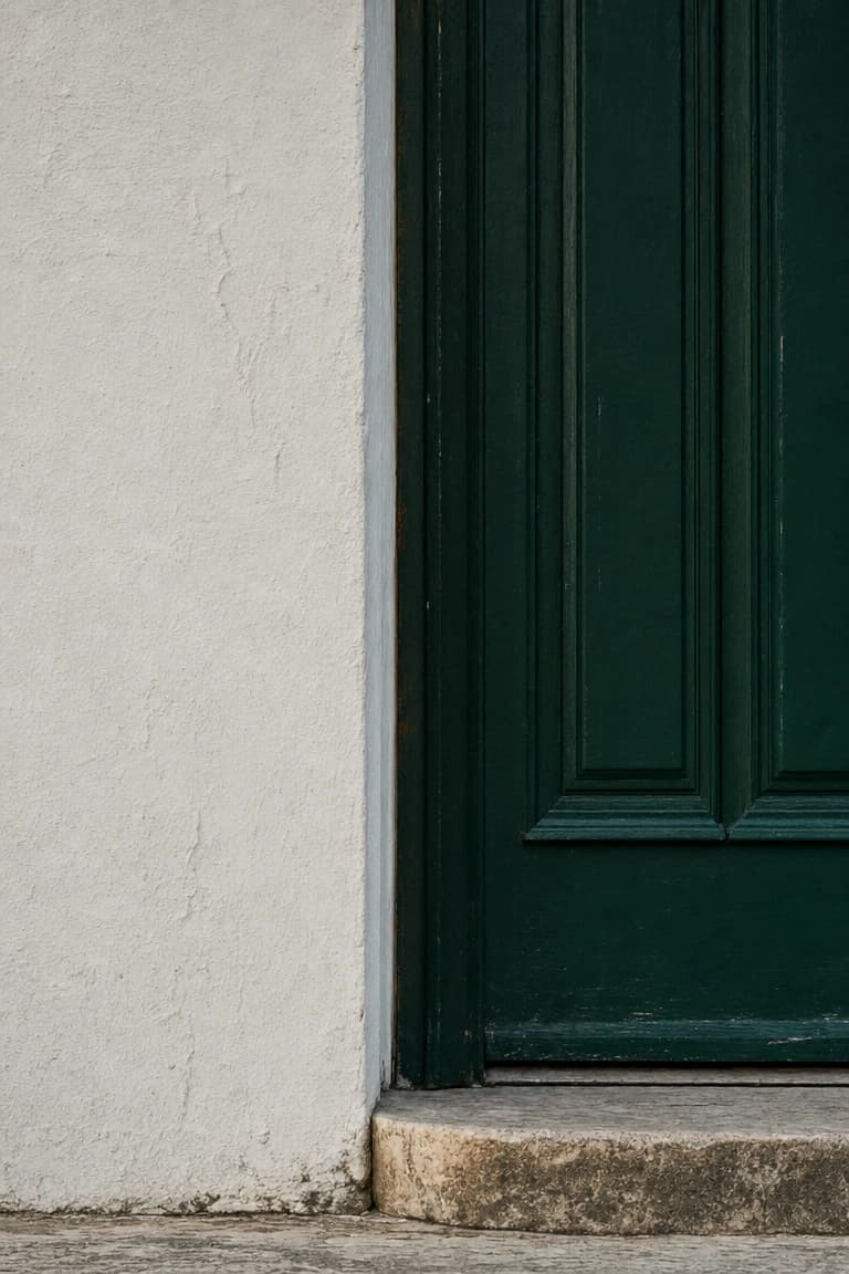 A deep green front door, partly beyond the frame