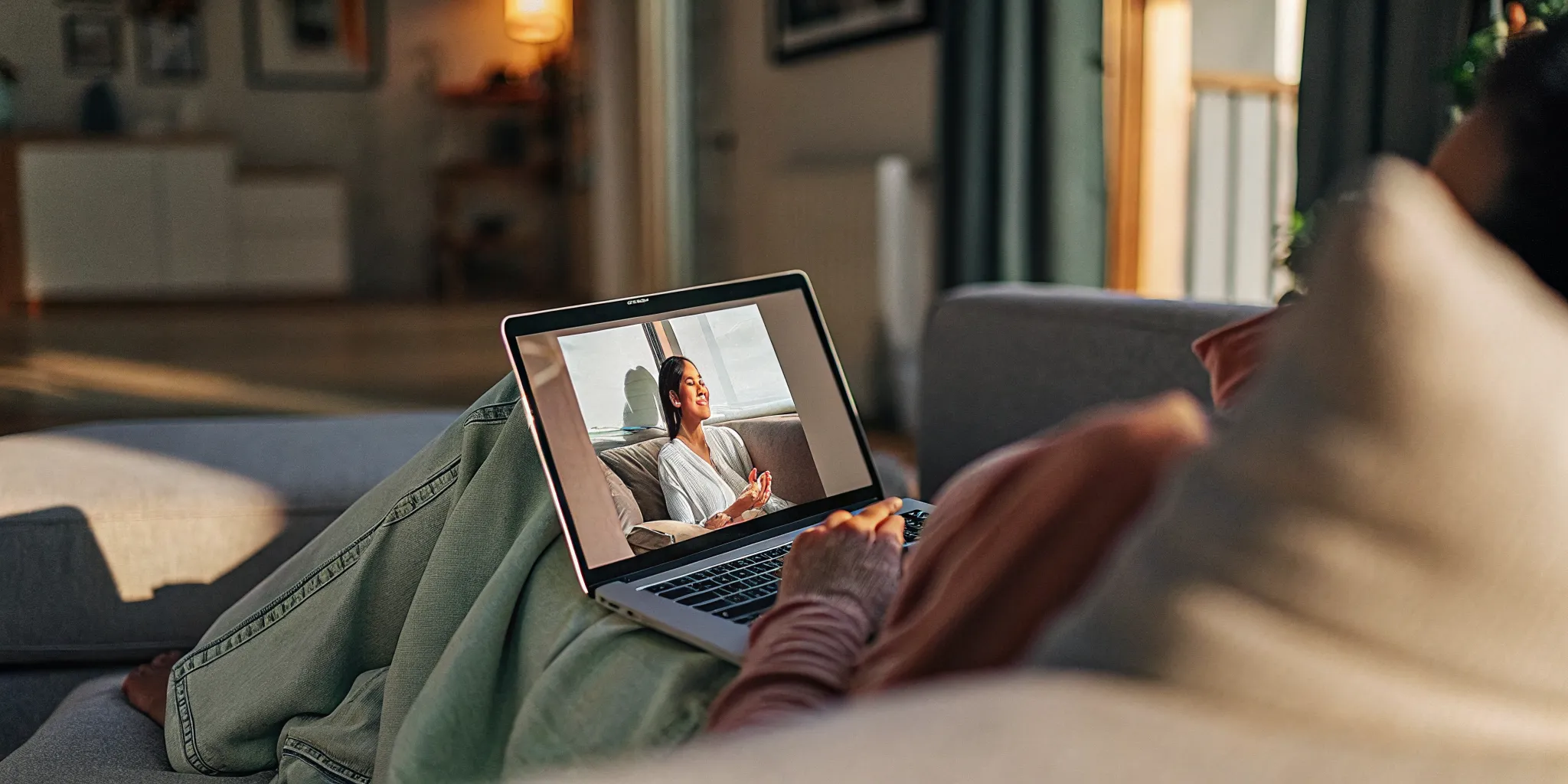 A person having an online therapy session from a calm home office with a laptop