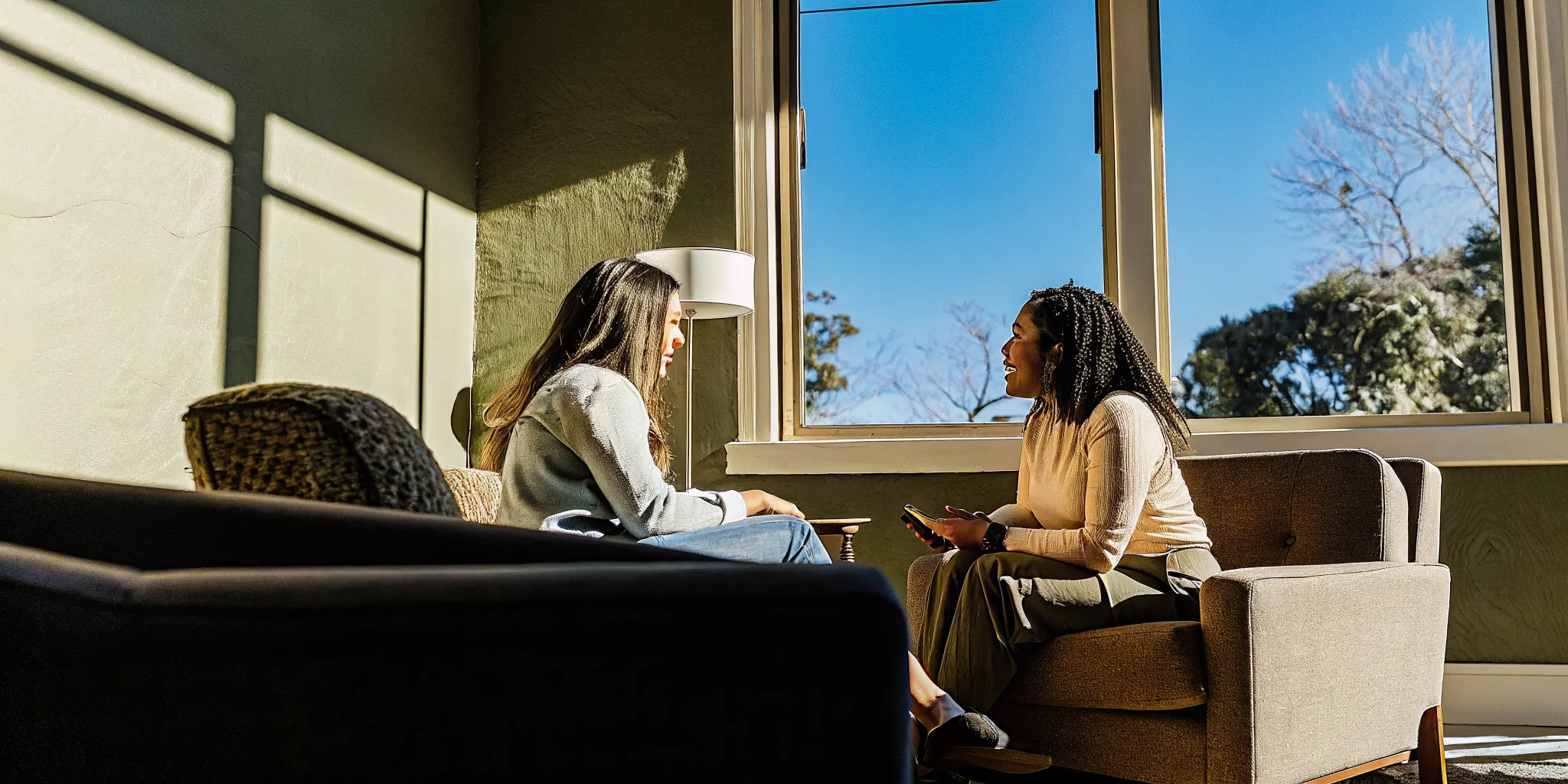 A therapist speaking warmly with a client in a bright counselling office